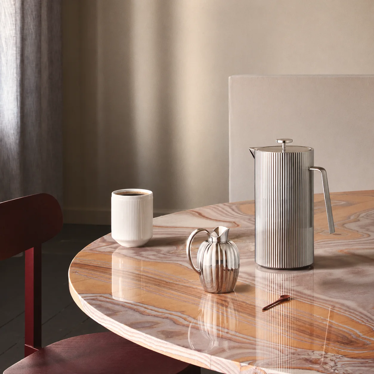 Georg Jensen Bernadotte coffee press on a marble breakfast table.